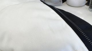 お洋服の生地の生地目に沿って色濃く染みこんで広がっている様なシミは油のシミです